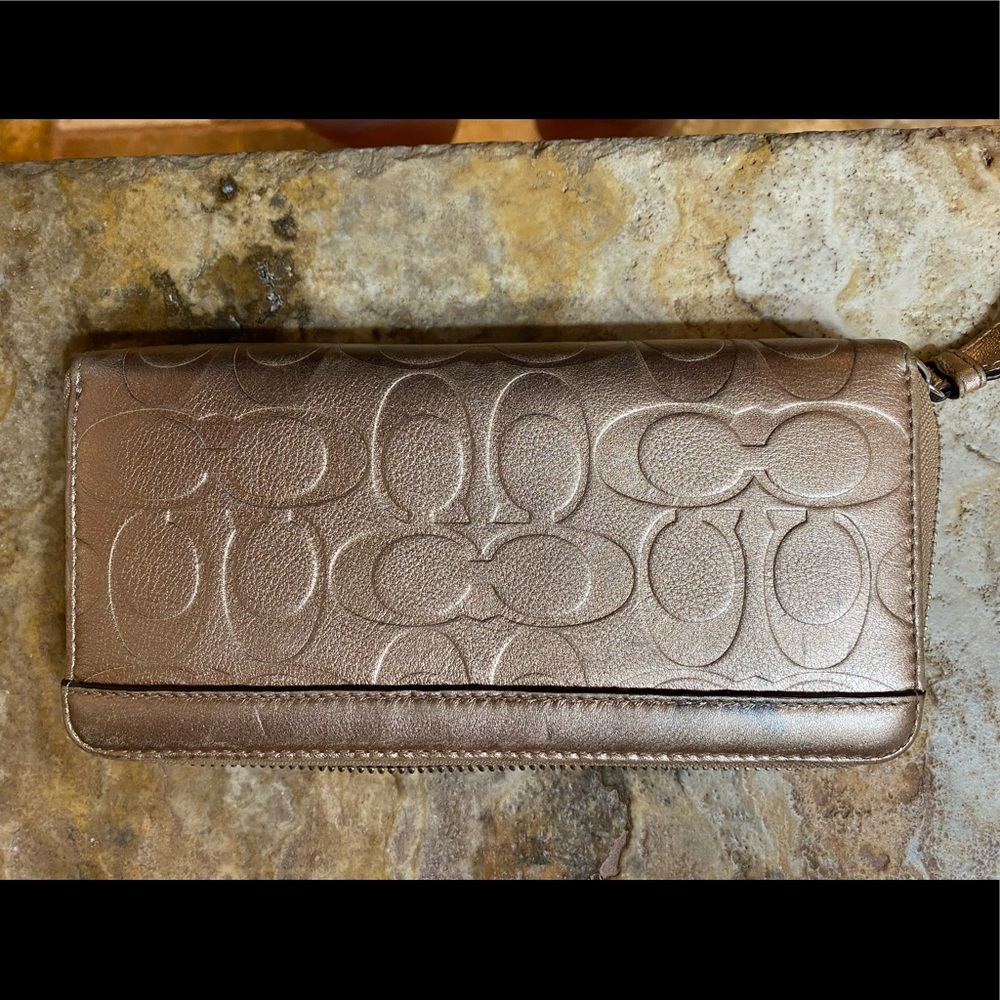 Coach embossed gold metallic wallet.
